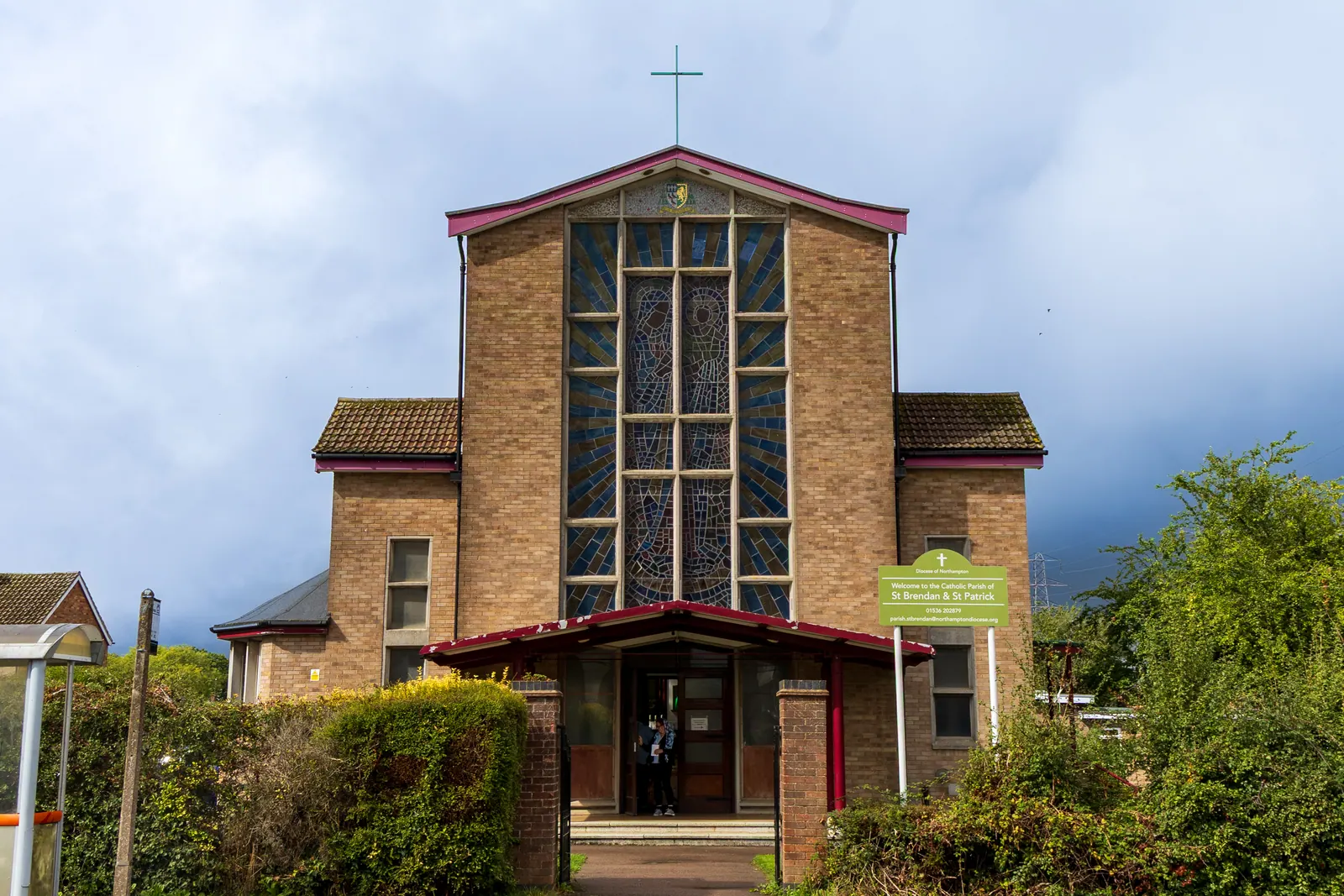 Front entrance and stained glass window of St Brendan’s Church in Corby