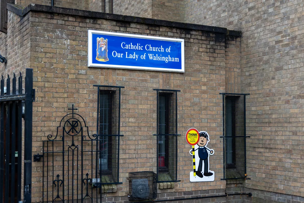 Our Lady of Walsingham Church sign beside the gate